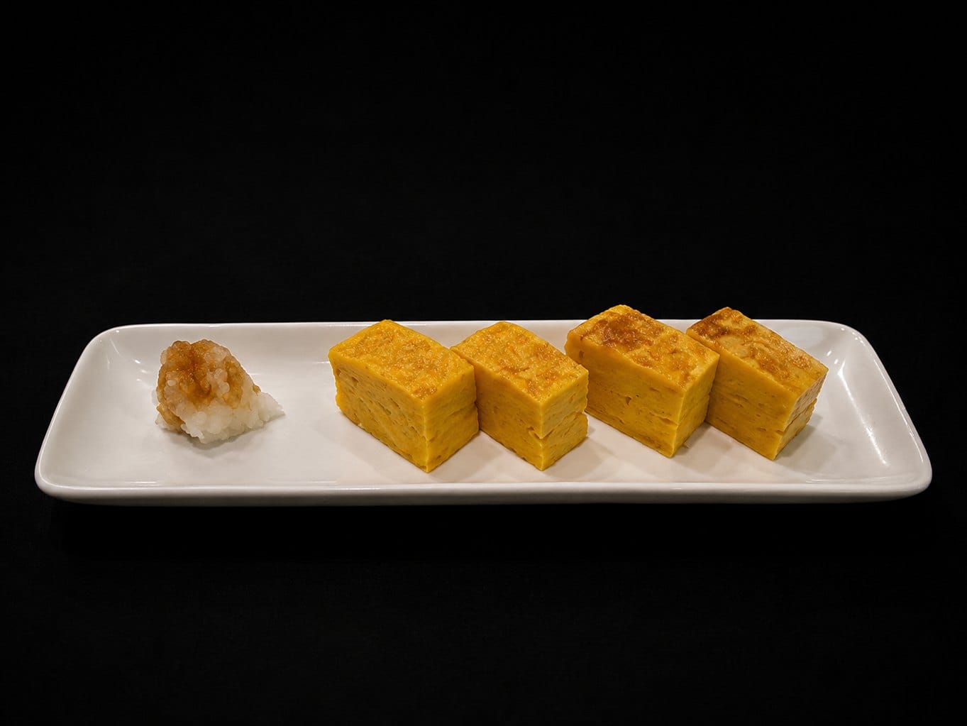 Atsuyaki tamago: slices of Japanese sweet omelette with grated daikon