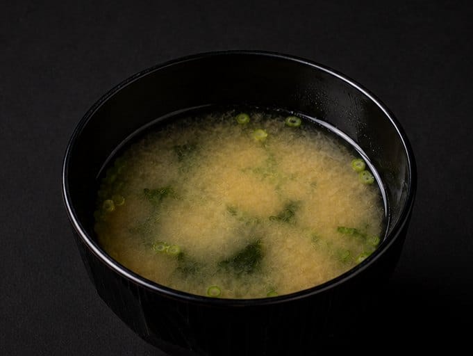 A bowl of miso soup with wakame and spring onion