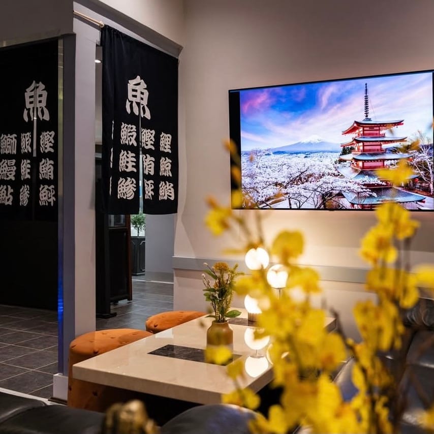 Black noren curtains beside a lounge corner inside Momo